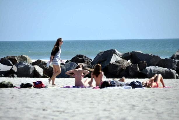 The female tourist was exposed to the sun on the beach and was attacked by crabs as raw oysters. She was so hurt that she yelled.