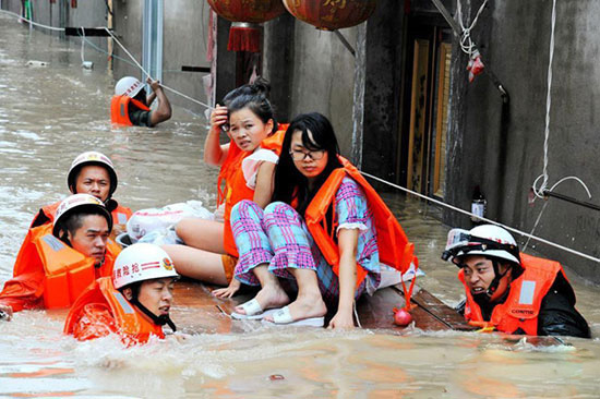 More than 300 people were trapped in a flooded migrant village caused by 